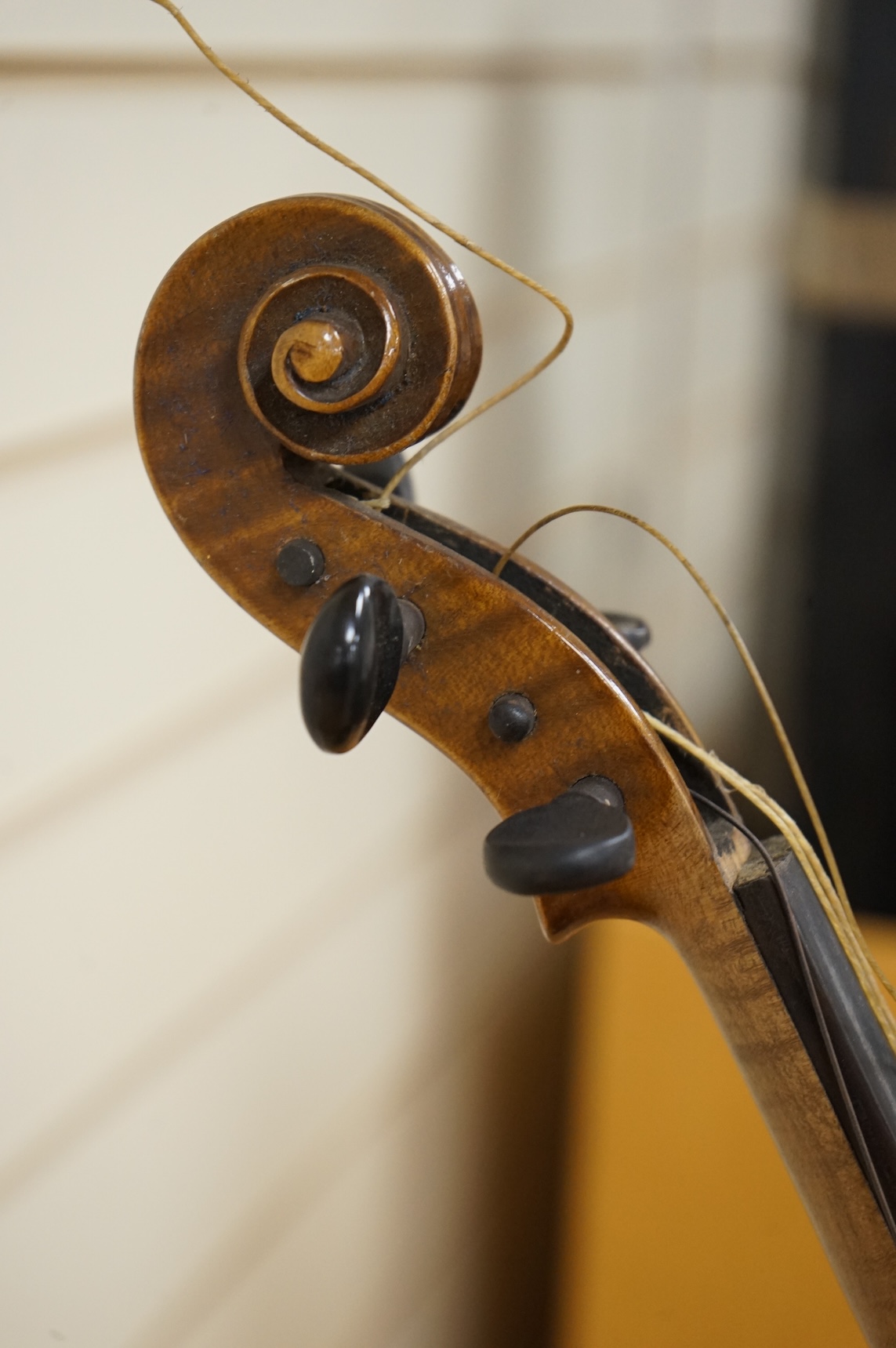 Three cased violins; a German Dresden violin, supplied by Campbell and co., Glasgow, together with another Dresden Stradivarius copy, and the remains of a European violin.